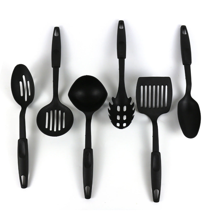 Zamora Mart kitchen set including utensils, pots, and cookware arranged on a countertop for cooking and meal prep.