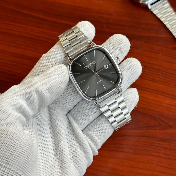 Casio square watch with black dial and silver case, featuring digital display and adjustable strap by ZAMORA MART.