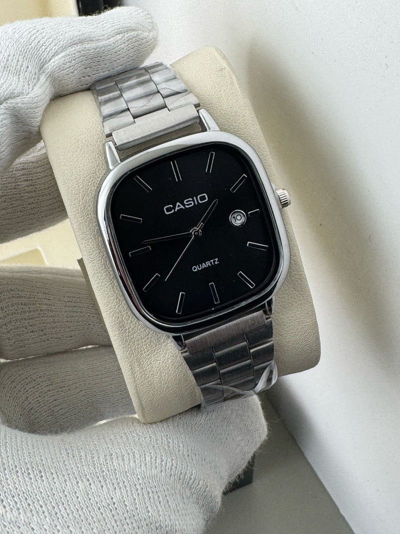 Casio square watch with black digital display and silver bezel, featuring a sleek, modern design by ZAMORA MART.