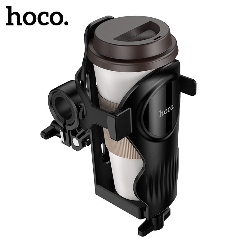 ZAMORA MART Feliz Cycling Water Cup Holder attached to a bicycle handlebar, holding a water bottle during a ride.