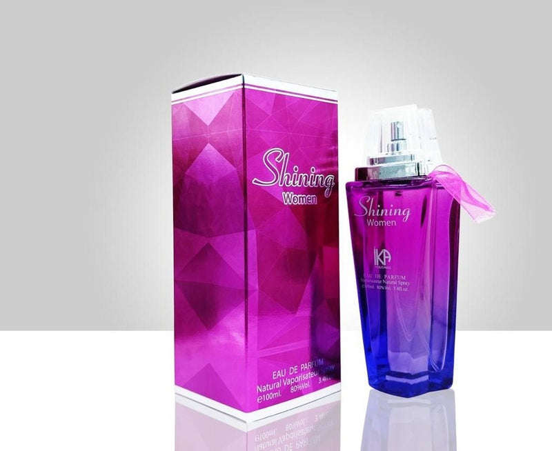 Shining Women eau de parfum by ZAMORA MART featuring a sleek glass bottle with a gold cap and elegant floral design.