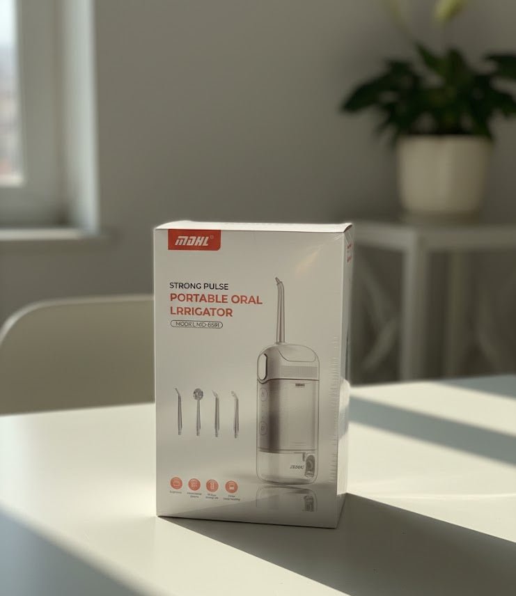 ZAMORA MART portable oral irrigator showing a compact device with a water reservoir and nozzle for dental cleaning.