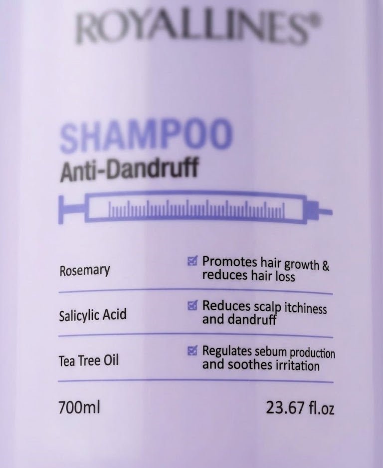 ZAMORA MART anti-dandruff shampoo bottle with white label and blue cap, placed on a white surface.