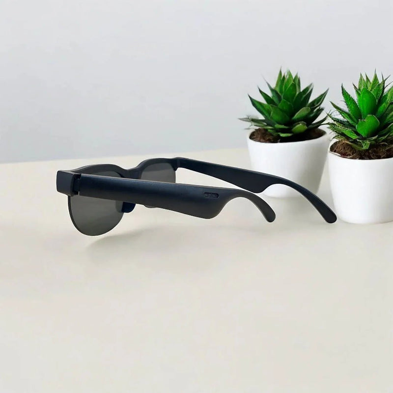 Wireless headset glasses by ZAMORA MART featuring sleek design with built-in audio speakers and transparent frame for hands-free calls.